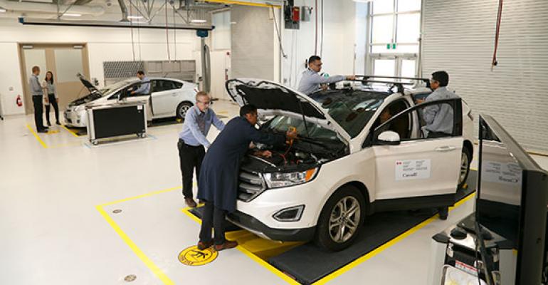 Engineers install instrumentation onto experimental vehicle at Canadian research facility.
