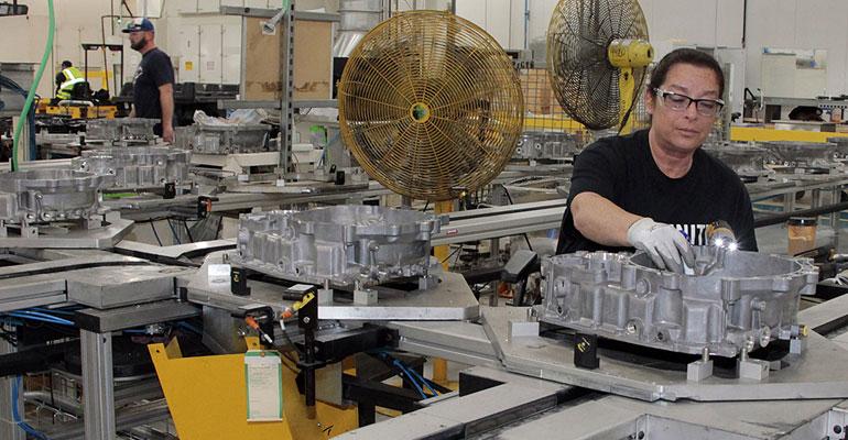 Employee at FCA US Kokomo Transmission Plant performs quality check on nine-speed bell housing.
