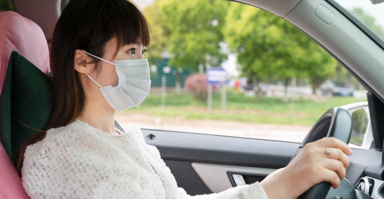 Masked Asian woman driver (Getty).jpg