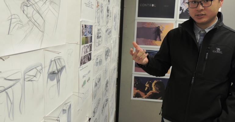 Enze Enzo Zheng explains his initial concept ideas during the initial design review 