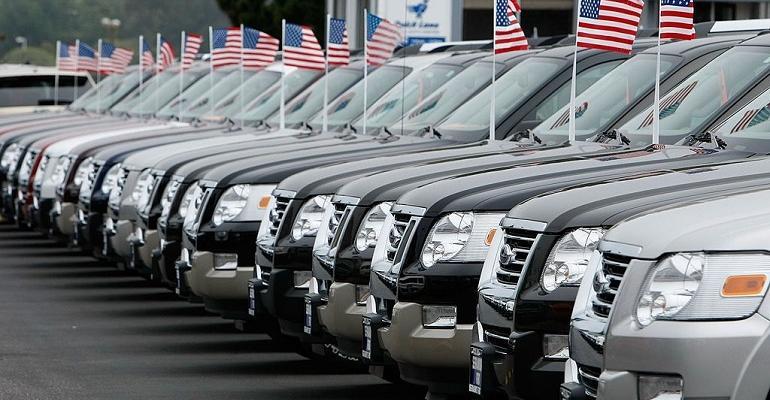 row of cars with american flags.jpg