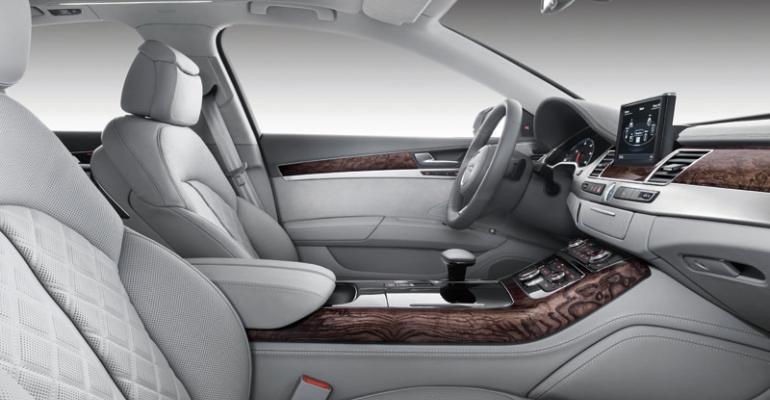 Audi A8 mixes Alcantara synthetic material and perforated patterned leather for seats plus ashwood trim for center console