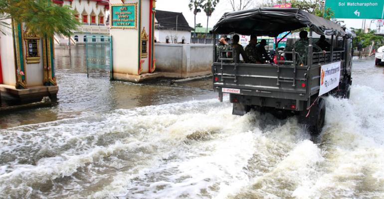 Thai Army truck driving through flooded street in Bangkok to help flood victims