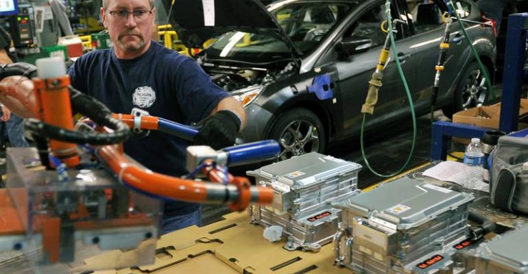 Mark Lynett installs battery in CMax hybrid at Michigan Assembly 