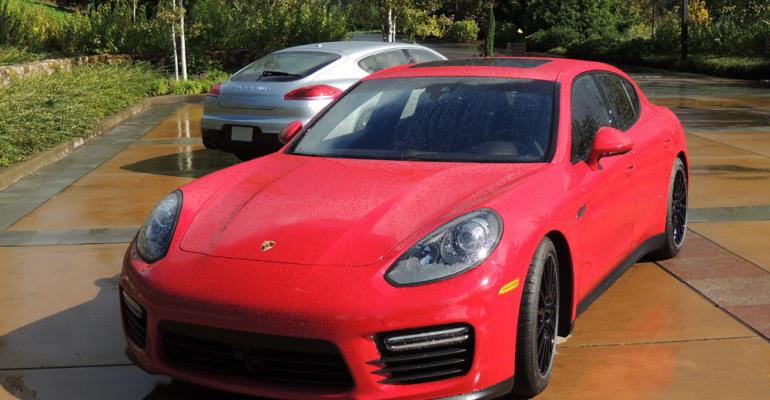 Red Porsche Panamera 4S in front of silver Panamera Turbo on display at Oregon press launch
