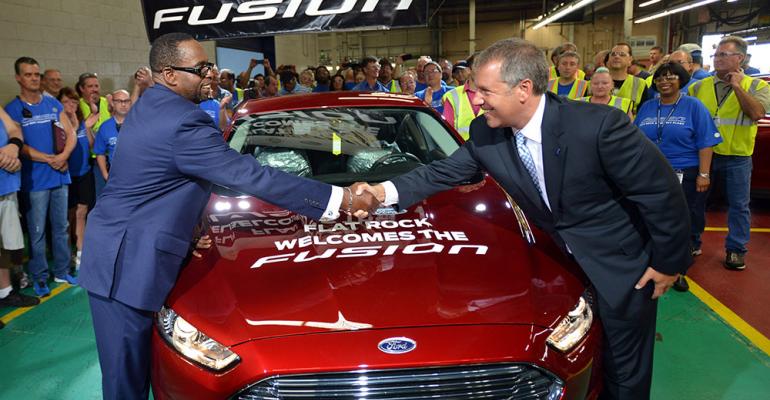 Joe Hinrichs right and UAW Vice President Jimmy Settles launch Fusion at Flat Rock last August