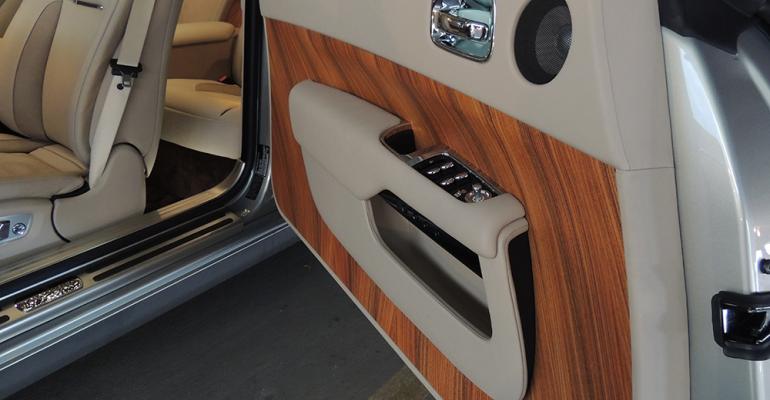 RollsRoyce Wraith tantalizes occupants with monogrammed head restraints enormous carriagestyle doors and mattefinish rosewood paneling canted at 55 degrees