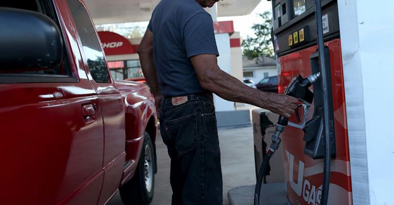 Falling gasoline prices pressure automakers trying to develop fuelefficient vehicles to meet government standards 
