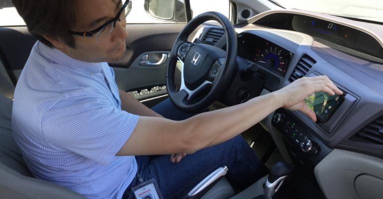 Shinichi ldquoMaxrdquo Akama Principal EngineerHonda Silicon Valley Lab activates a prototype infotainment system that uses a smartphone as a carrsquos database