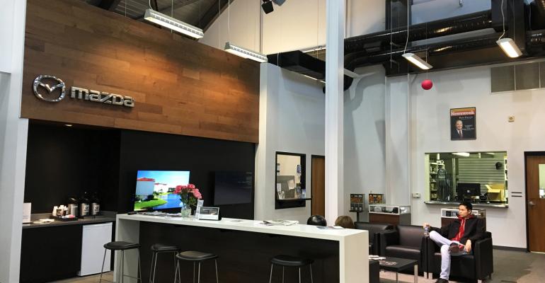 Darrowrsquos Mazda store features muted blackandwhite color scheme natural materials and chrome Mazda signage 