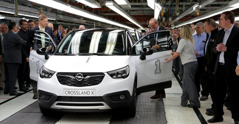Opel President and CEO Neumann center right OpelVauxhall vice presidentmanufacturing Kienle prepare to drive first Opel Crossland X off assembly line 