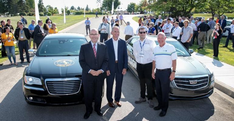 Executives from Continental from left and Magna celebrate safe arrival of selfdriving demo vehicles at MBS automotive conference in northern Michigan on Monday 