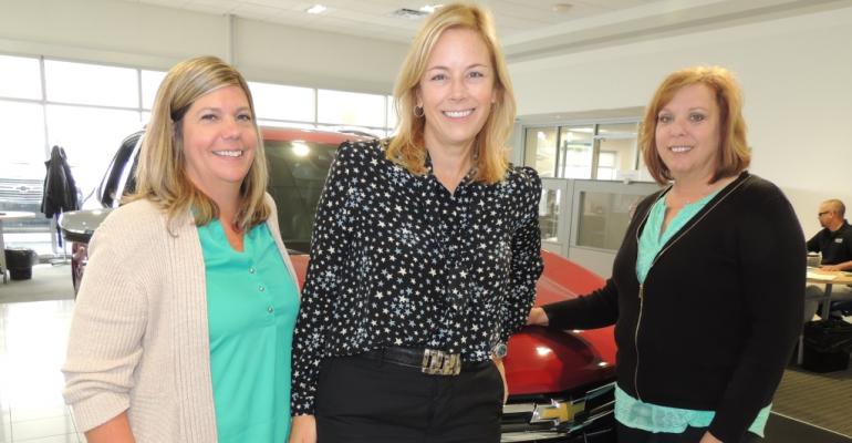 From left Simpson Coleman and Jensen in John Bowman Chevrolet showroom    