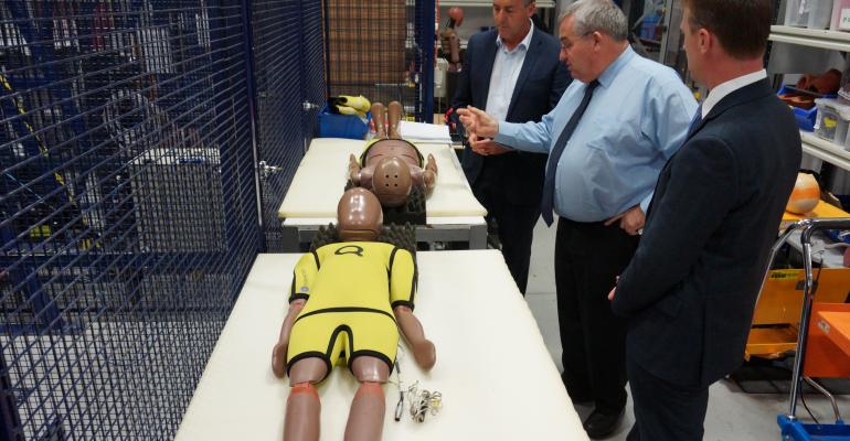 left to right Transport Minister Chester Crash Lab General Manager Dal Nevo and ANCAP CEO Goodwin examine new test dummies