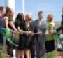 Maureen LaFontaine flanked by family members including son Ryan at left cuts ribbon to open new ldquogreenrdquo facility