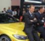 BMW board members Herbert Diess left and Ian Robertson rest on hood of allnew M4 coupe unveiled in Detroit