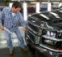 GM Arlington assembly plant employee Mark Magallon shines Chevy Tahoe badge