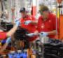 Cummins employee inserts piston in Nissan 50L diesel as part of pilot production
